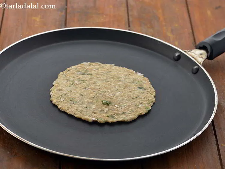 Step 17 – <p>Heat a non-stick tava (griddle) and place the <strong>Oats Roti</strong> on it. Cook the roti …