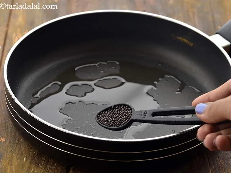 Step 8 – Once the oil is hot, add the mustard seeds.