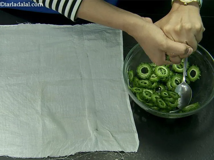 Step 6 – Squeeze all the water from the bitter gourd using your hands.