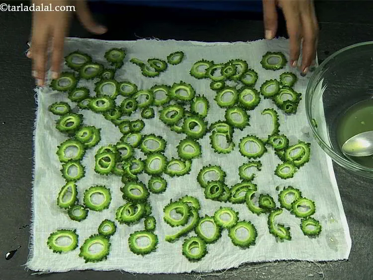 Step 26 – While drying the karela slices on a muslin cloth, space them well so they dry …