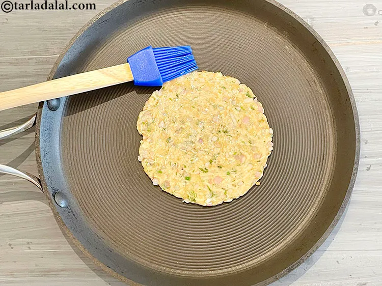 Step 18 – Brush 1/8 teaspoon oil on the top of the roti. We have used very little …