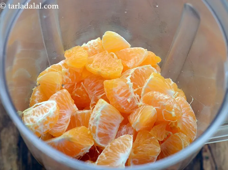 Step 17 – Transfer the orange pieces into a mixer / blender jar to make homemade orange juice.