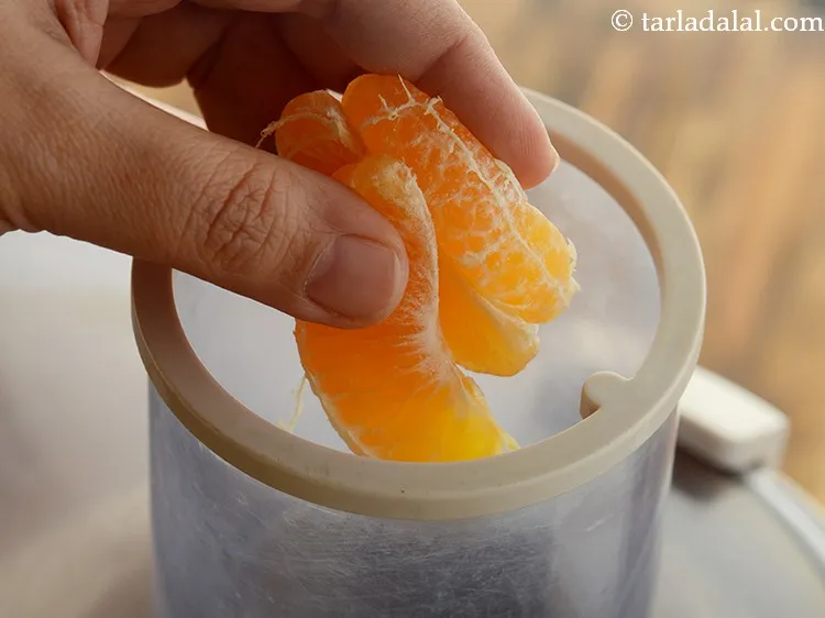 Step 27 – Add a few orange segments at a time in the juicer.