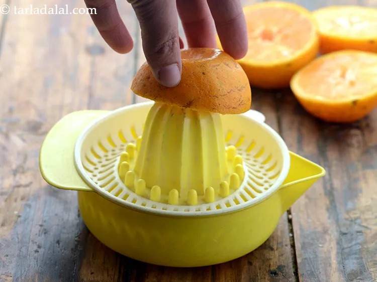 Step 32 – Place one orange halve upside down on the tip of the citrus juicer and press …