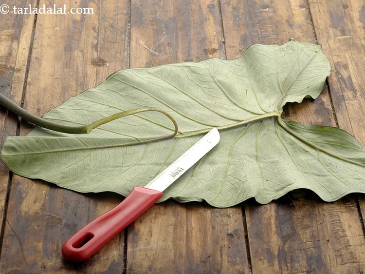 Step 13 – Place the leaves with vein side facing upwards and slice in the center to remove …