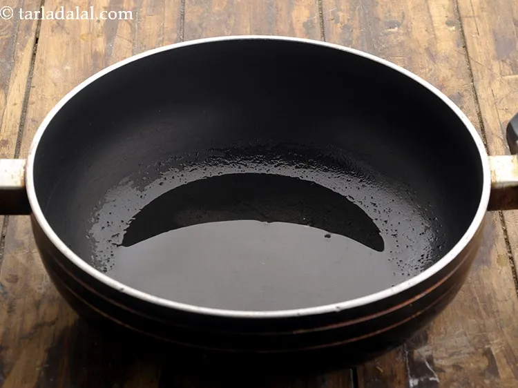 Step 30 – To temper the&nbsp;<strong>paatra | Gujarati paatra |&nbsp;Maharashtrian&nbsp;alu vadi |</strong>&nbsp;heat the oil in a deep non-stick …