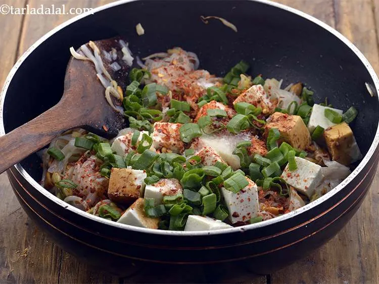 Step 21 – Add the finely chopped spring onion greens. Use fresh ones and if possible cut with …