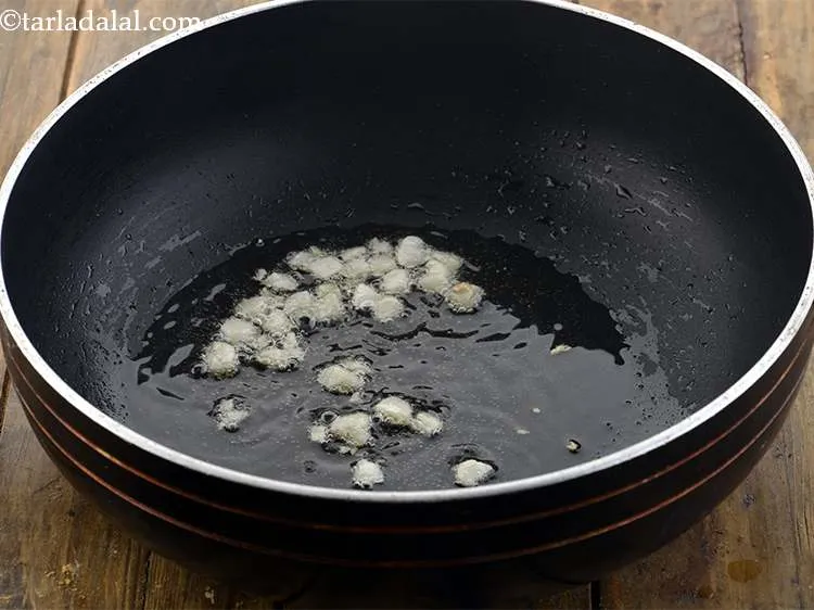 Step 9 – When the oil it hot add the garlic. This is very important as it gives …