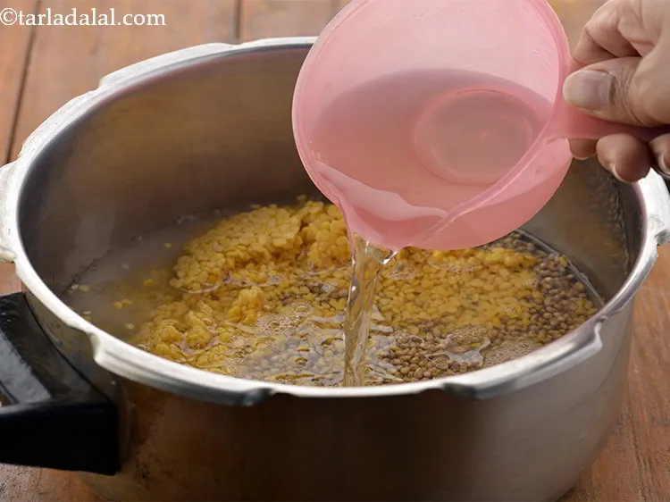 Step 12 – Add 2 cups of water in the pressure cooker.