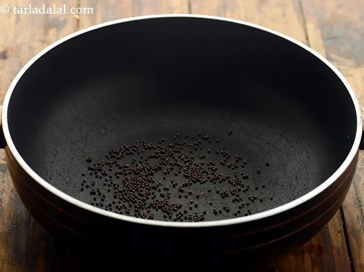 Step 11 – To make <strong>chana palak dal</strong>, heat a deep non-stick pan on a medium flame and …