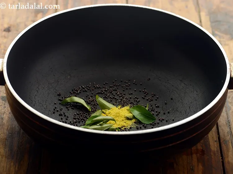 Step 13 – Add asafoetida and dry roast for about 30 seconds or till the mustard seeds crackle.