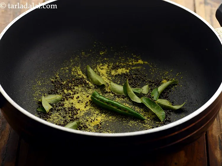 Step 14 – Lower the flame, add the green chilli.