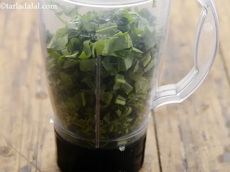 Step 7 – Transfer the spinach to a mixer jar.