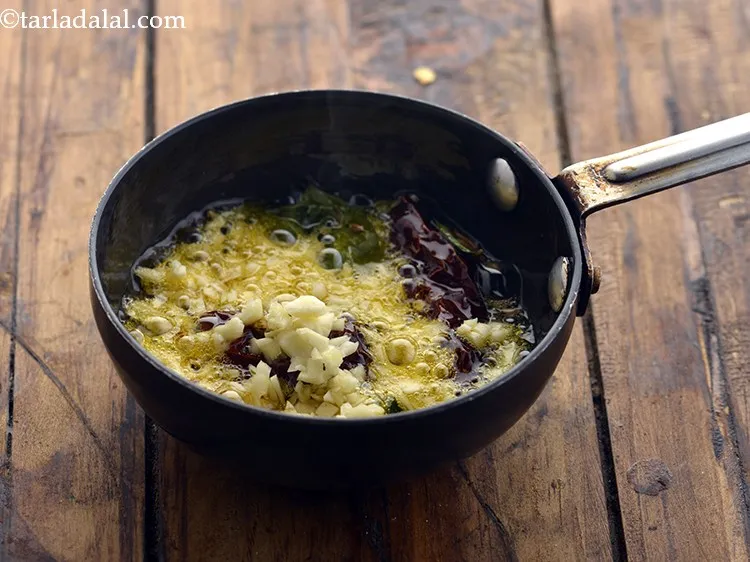 Step 37 – Add the garlic. The toasted garlic adds a nice crunch to the palak khichdi.