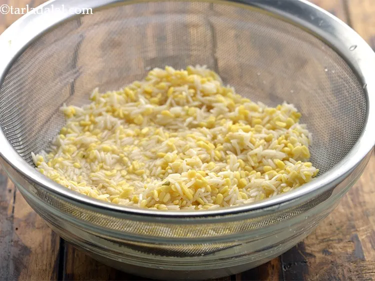 Step 10 – After half an hour, drain the dal-rice well. We will now proceed to make the …