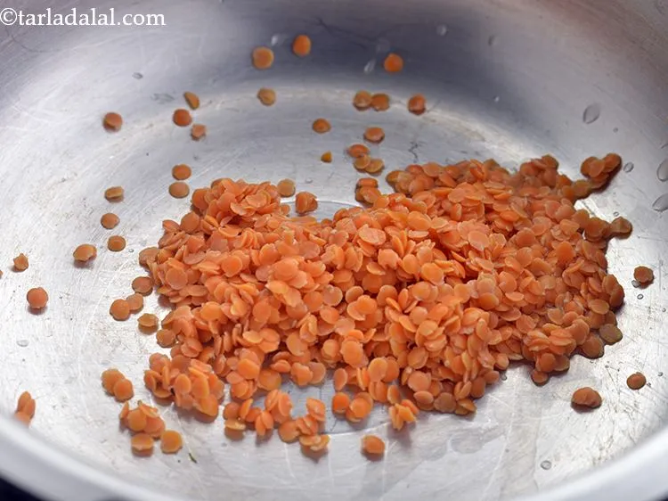 Step 10 – Transfer the masoor dal into a pressure cooker to make <strong>masoor dal pani for babies</strong>.