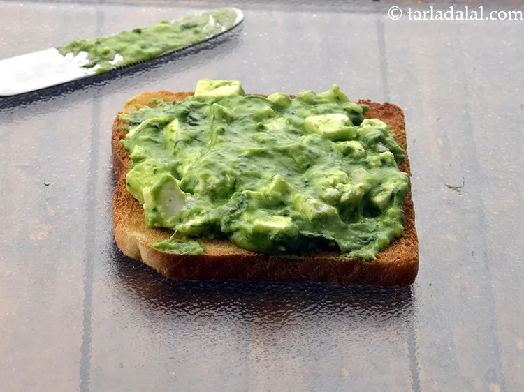 Step 21 – Spread 2 tbsp of the prepared <strong>palak paneer mixture</strong> over it and spread it evenly.