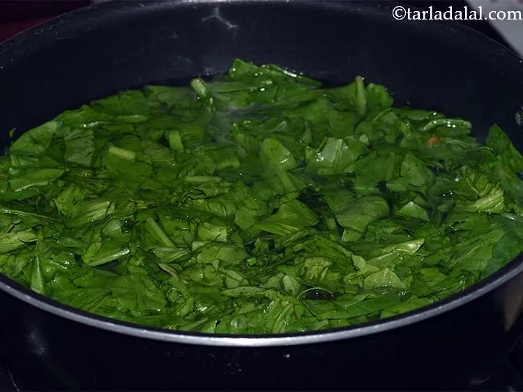 Step 11 – Now add the spinach leaves.&nbsp;Cook the spinach leaves in the water for 2-3 minutes till …