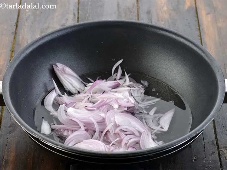 Step 2 – Now add the sliced onions.