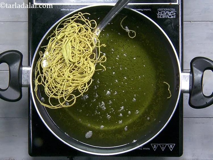 Step 29 – Flip and fry multiple times till the palak pudina sev is evenly cooked from all …