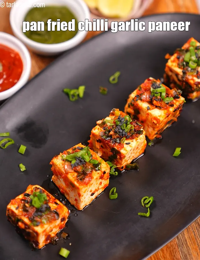 Step 12 – Serve <strong>chilli garlic paneer</strong> immediately garnished with <a href="https://www.tarladalal.com/glossary-black-sesame-seeds-kala-til-kale-til-862i">black sesame seeds (kala til)</a> and <a …