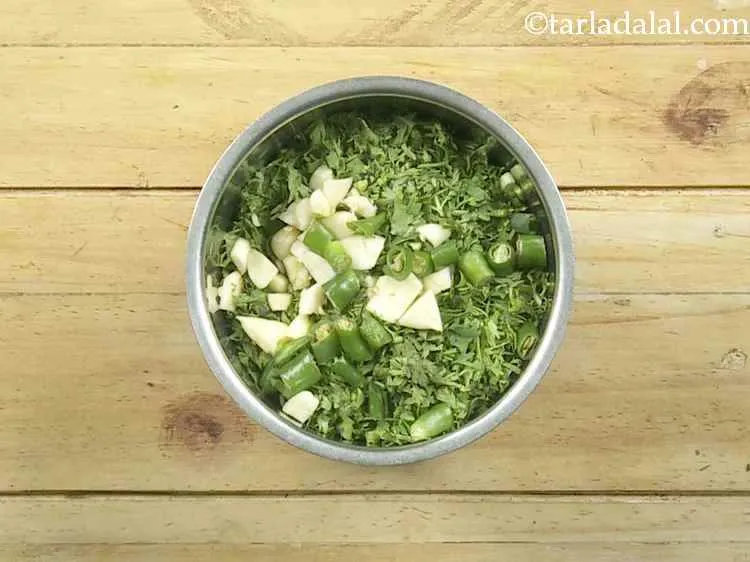 Step 25 – Then add roughly chopped garlic and green chillies in the mixer and blend till smooth …