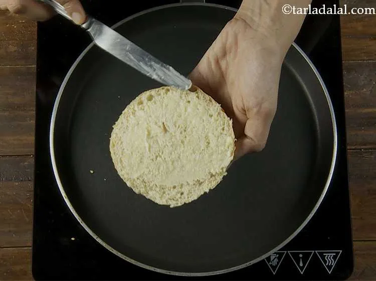 Step 13 – Apply a little butter on the cut sides of each half of the burger bun.
