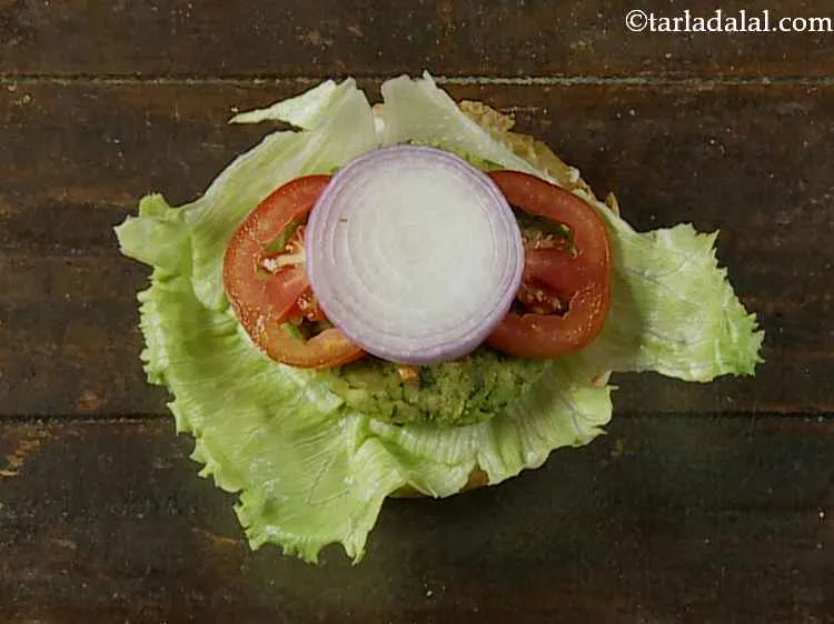 Step 21 – Then place 2 tomato slices and 1 onion slice over it.