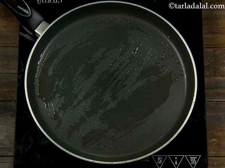 Step 9 – Heat a non-stick tava (griddle) and grease it with little oil. We are going to …