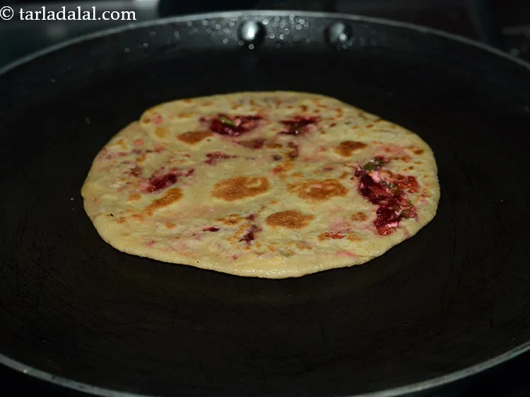 Step 22 – Turn the paratha and allow it to cook slightly on the other side as well.