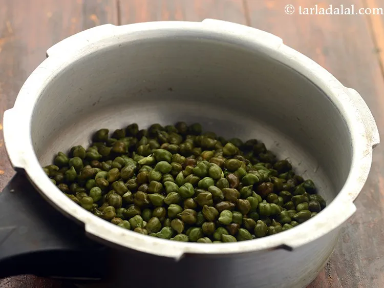 Step 11 – Transfer the hara chana into a pressure cooker.