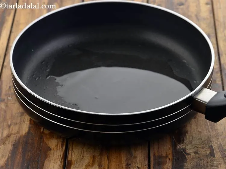 Step 12 – Heat the oil in a broad non-stick pan.