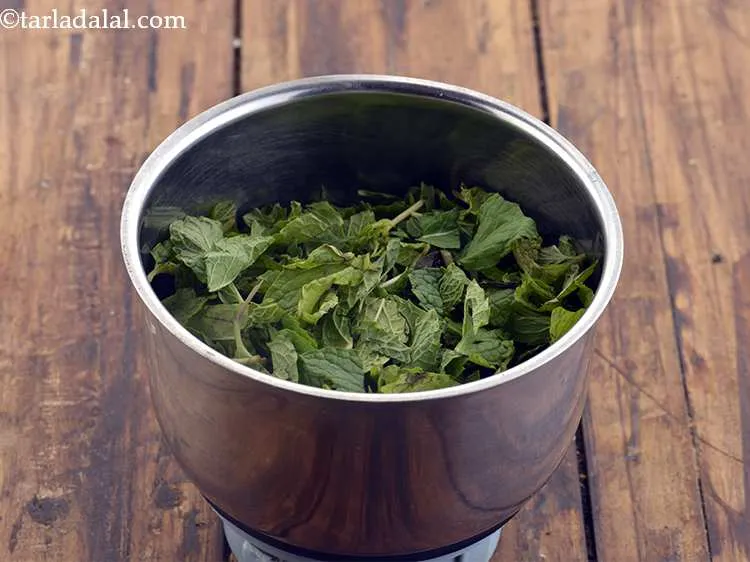 Step 32 – Add chopped mint leaves (phudina) into a mixer jar.