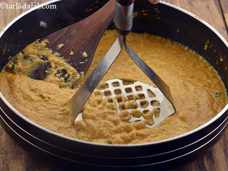 Step 19 – Mash the mixture well using a potato masher.