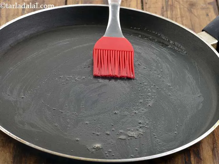 Step 53 – Take a tava and heat it up on a medium flame. Apply a little oil/butter …