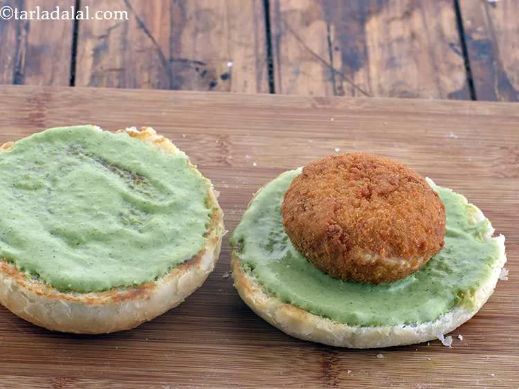 Step 56 – Place a cutlet over the lower half of the bun.