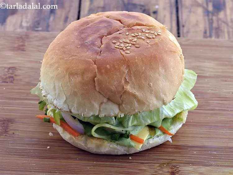 Step 61 – Cover with an upper half of the bun with the buttered-spread side facing down. Press …