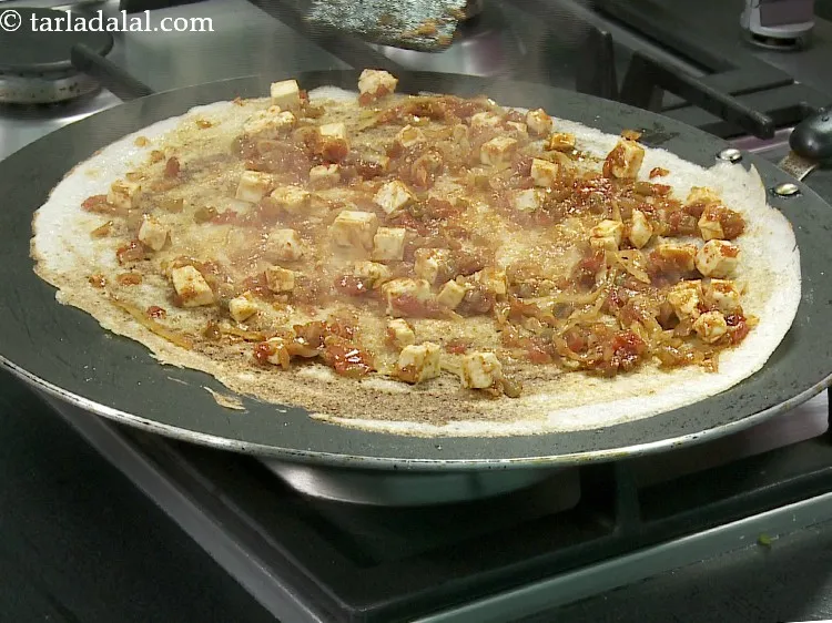 Step 33 – Cook <strong>cottage cheese chilli dosa</strong> on a medium flame for &frac12; minute. No need to …