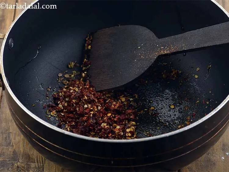Step 7 – Now add coarsely powdered dry Kashmiri red chillies. You can increase or decrease the amount …