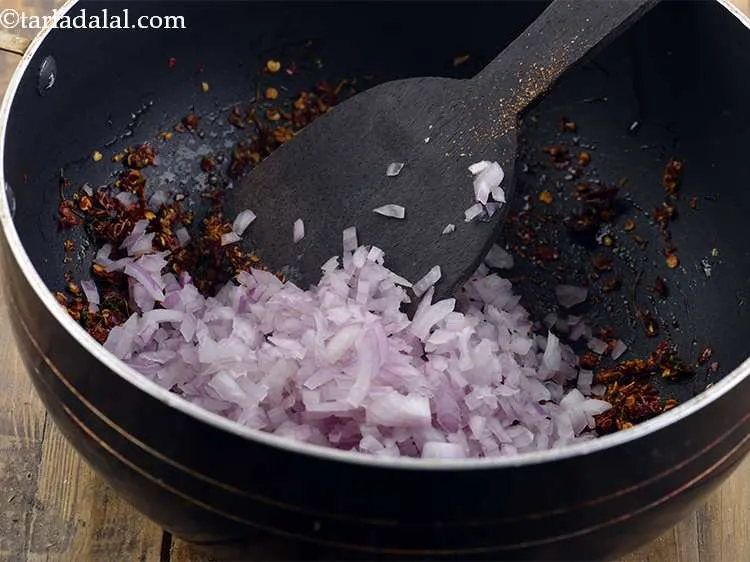 Step 10 – Now add the onions and saute for 1 minute.