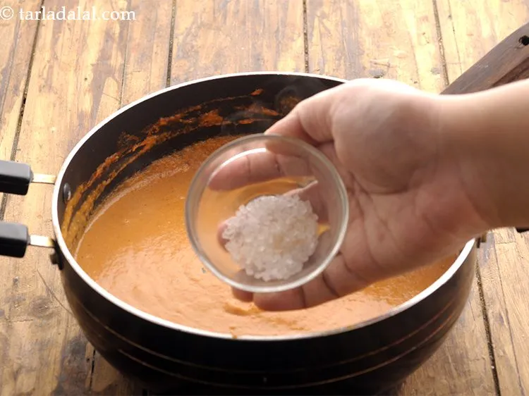 Step 23 – Add the sugar. This will balance out the sourness from tomato and curd if any.