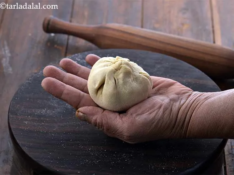 Step 20 – Bring the sides together to form a ball, remove the excess dough and seal it …