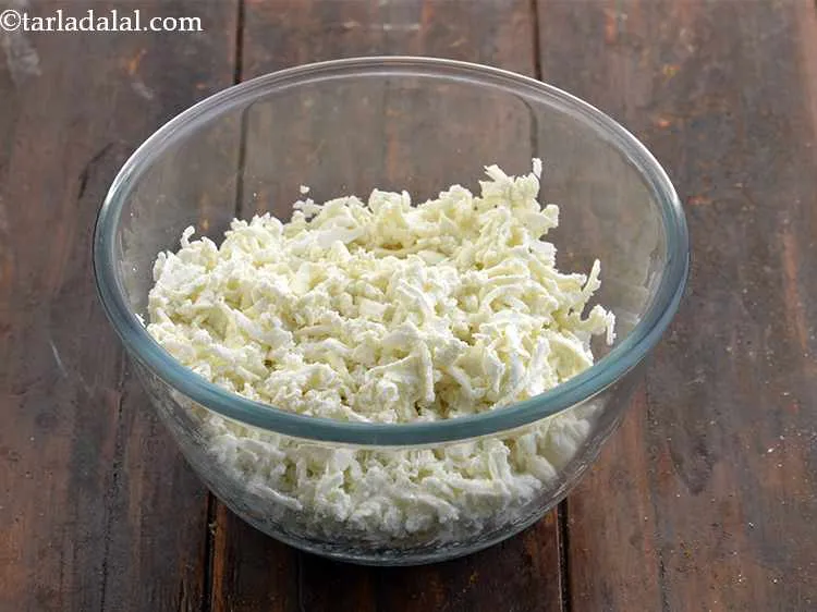 Step 8 – Place the grated paneer in a deep mixing bowl. Grating the paneer allows it to …