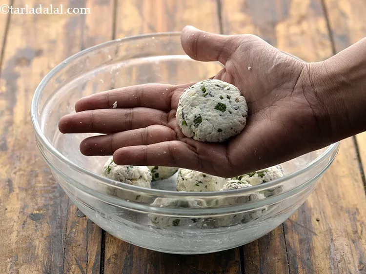 Step 12 – Further, shape each portion into 37mm. (1 1/2 &quot;) diameter flat round tikki.