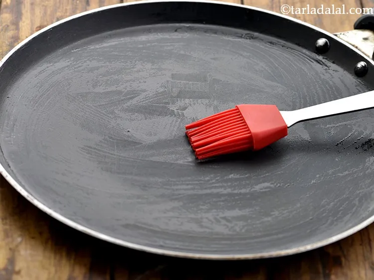Step 13 – Once the tikkis are shaped, heat a non stick tava (griddle) and grease it lightly …
