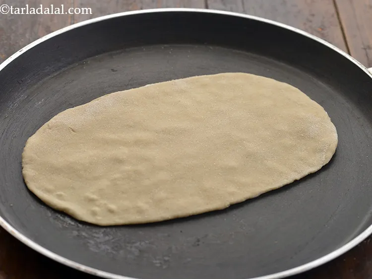 Step 18 – Heat a non-stick tava (griddle) and place the pita bread on it.