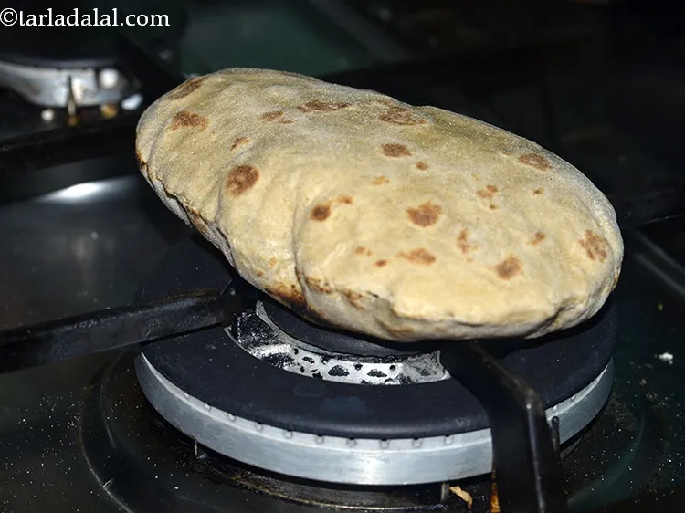 Step 21 – Cook it on an open flame till it puffs up and brown spots appear on …