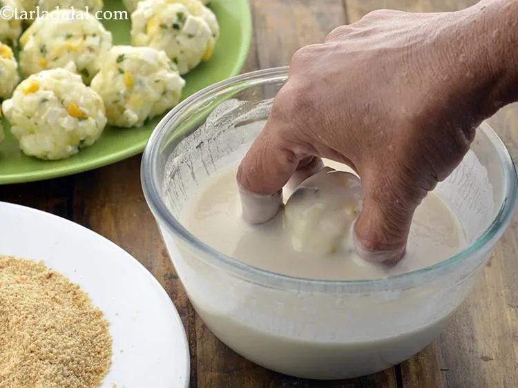 Step 22 – Dip a ball into the maida-water mixture.