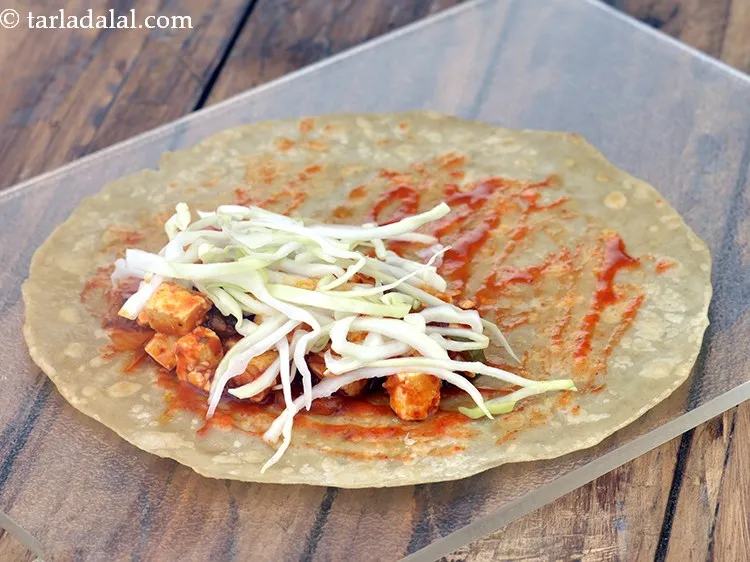 Step 22 – Top <strong>paneer schezuan Frankie</strong> with 1 tbsp of cabbage evenly over it. You can also …