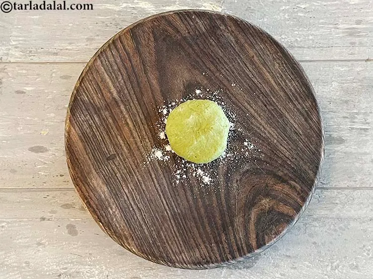 Step 26 – Flatten one portion in between your palms. Dip in flour and dust off excess flour.